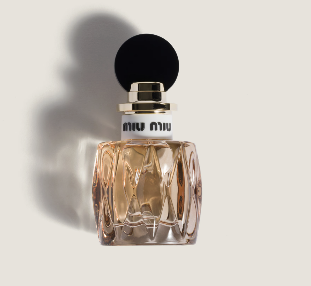Miu Miu Miutine Eau de Parfum 50ml in amber glass sculptural bottle with black circular cap and gold collar