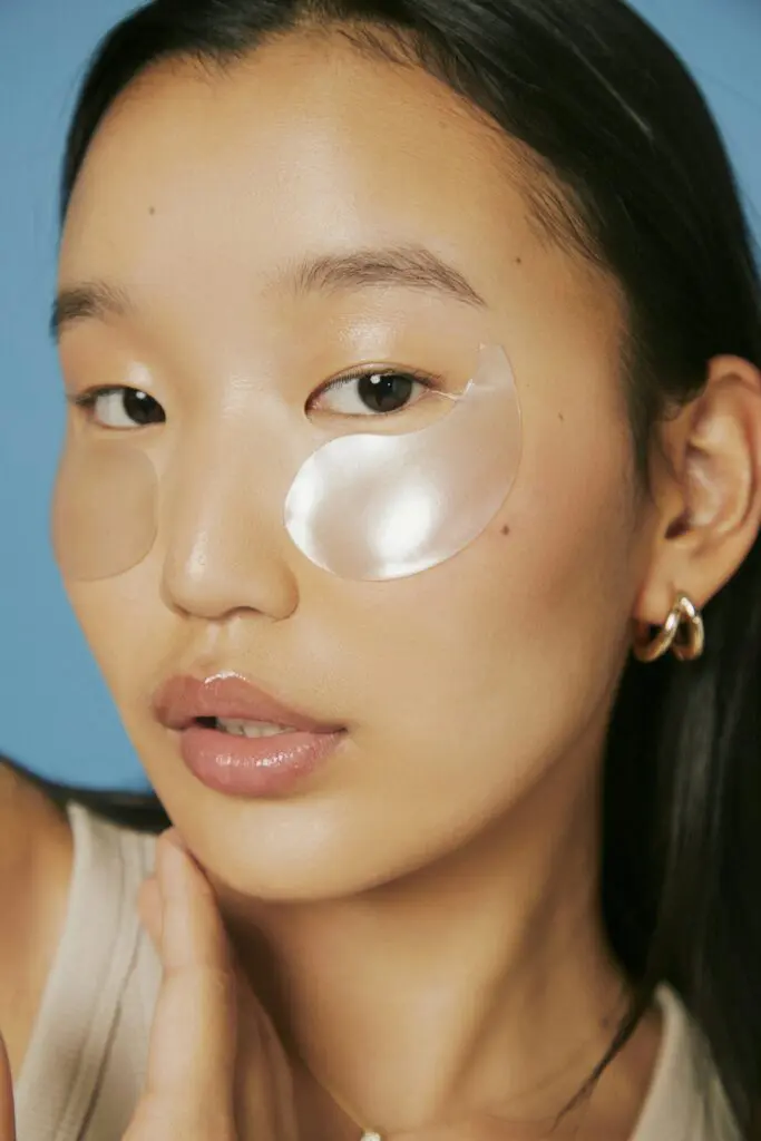 woman wearing eye patches under her eyes for skincare